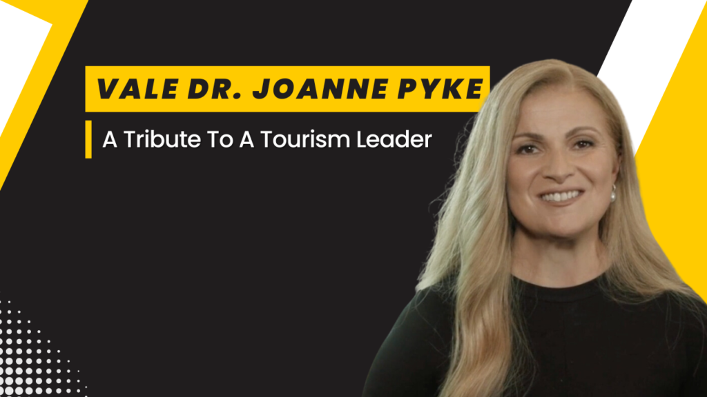 A yellow white black theme Podcast episode title - Vale Dr. Joanne Pyke: A Tribute To A Tourism Leader. Featuring Despina Karatzias head shot photo.